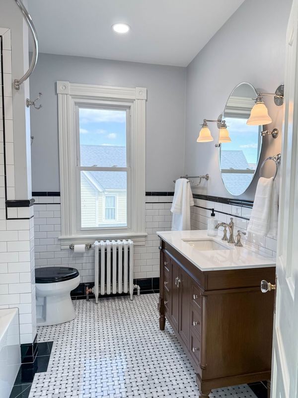 Black and white tile, wood vanity, a bathroom remodel by Sidney Design & Build in Winchester, VA