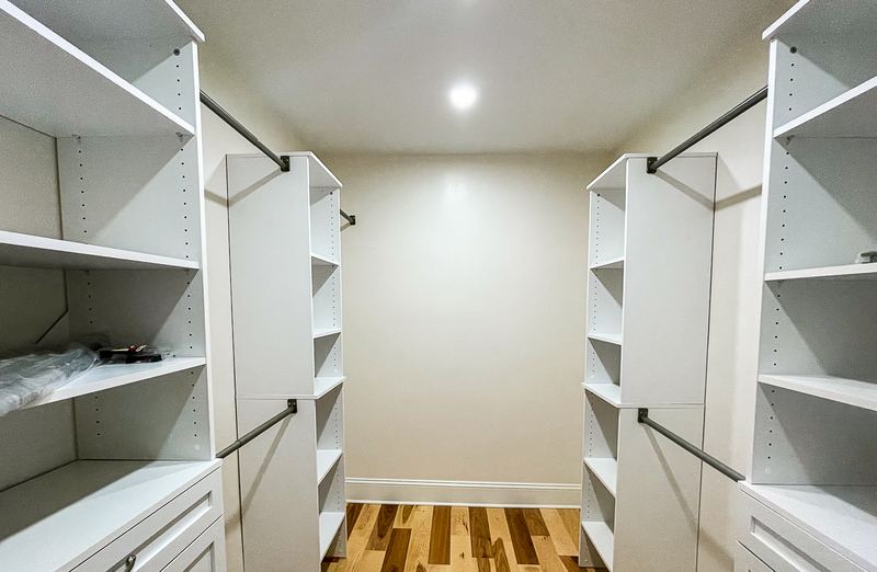 Walk in closet with shelving on both sides, a custom closet by Sidney Design & Build in Winchester, VA