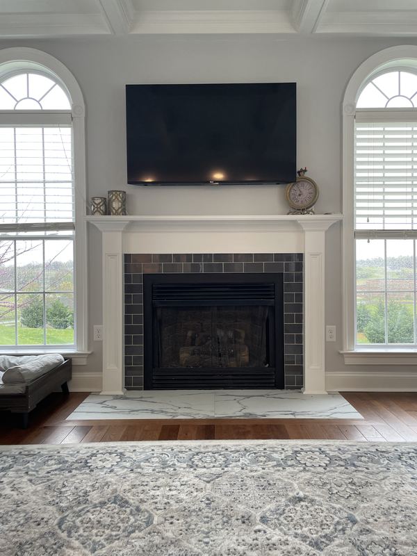 Fireplace between arched windows, a fireplace renovation by Sidney Design & Build in Winchester, VA
