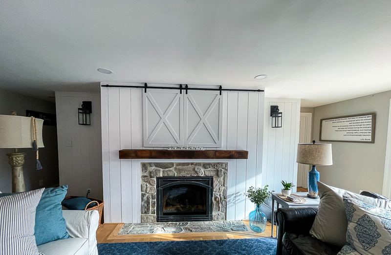 Barn doors over the TV, a fireplace renovation by Sidney Design & Build in Winchester, VA