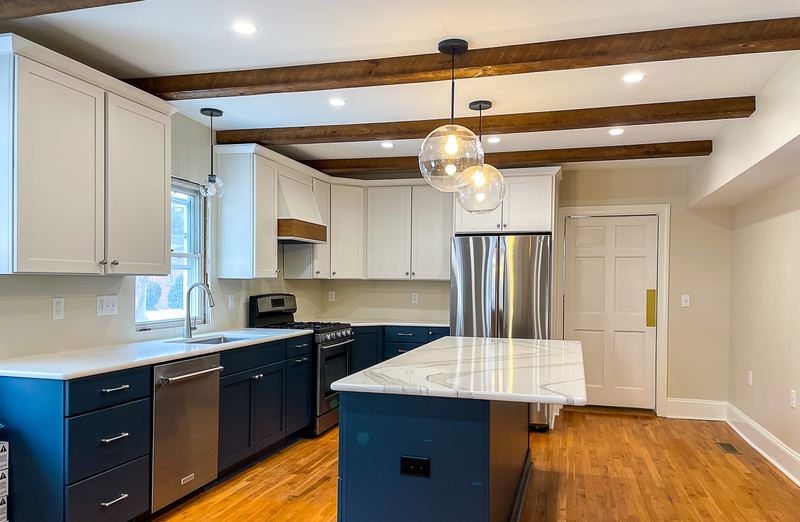 Navy lowers under exposed beams, a kitchen remodel by Sidney Design & Build in Winchester, VA