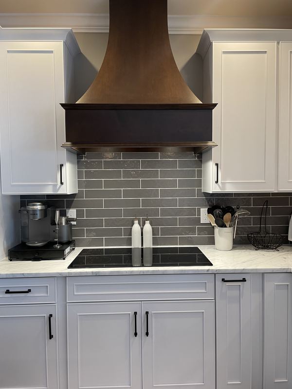 Copper hood over a gray subway backsplash, a kitchen remodel by Sidney Design & Build in Winchester, VA