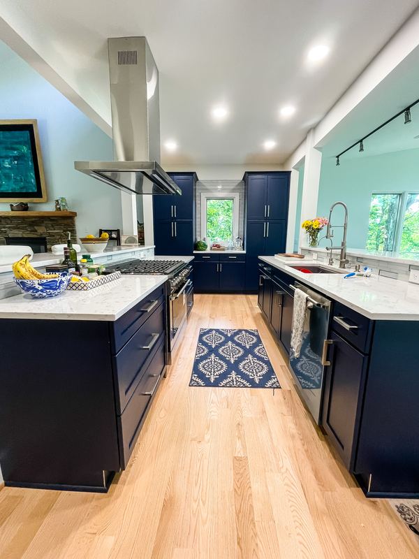 Navy galley with an island hood, a kitchen remodel by Sidney Design & Build in Winchester, VA