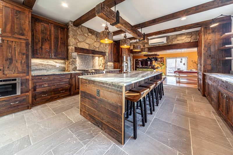 Stone, reclaimed wood and a long island, a kitchen remodel by Sidney Design & Build in Winchester, VA