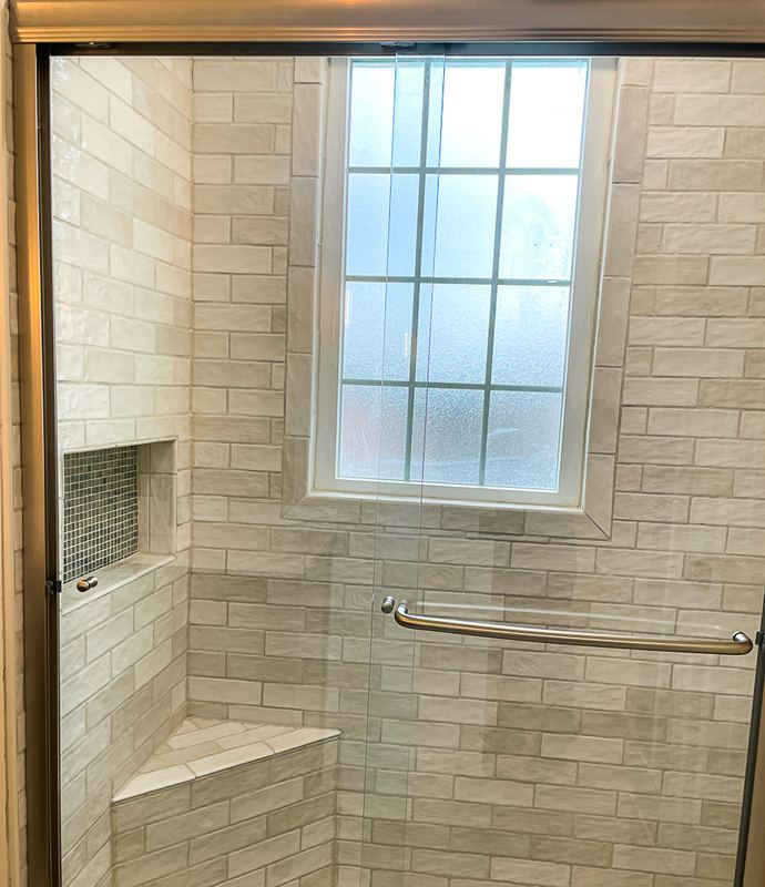 Bench seat and a corner niche, a walk in shower by Sidney Design & Build in Winchester, VA