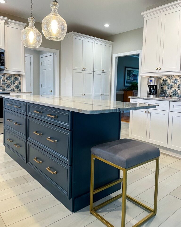 Navy kitchen island with brass cabinet pulls and glass pendant lights, custom cabinetry in Winchester, VA