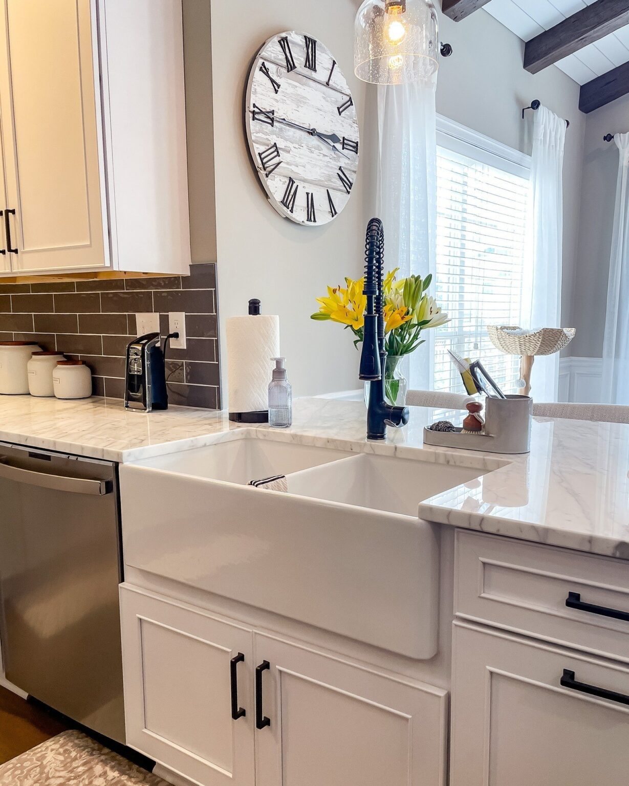 Farmhouse sink set in marble look countertops with white shaker cabinets, kitchen cabinets and countertops in Winchester, VA