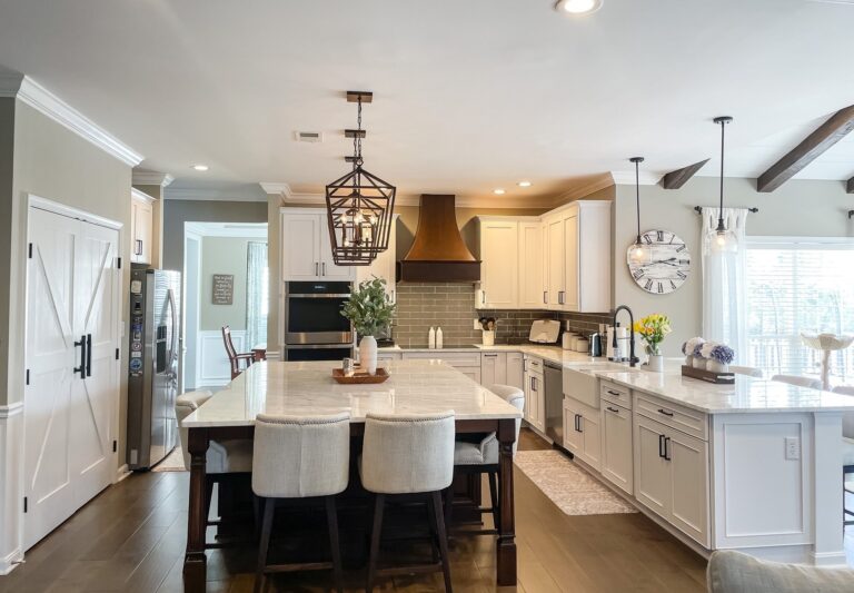 Open plan kitchen remodel with a large white island, lantern pendants and seating for four in Winchester, VA